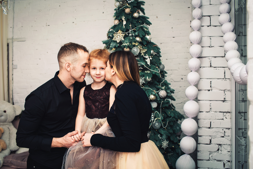 Рыжеволосая девочка с родителями на новогодней фотосессии