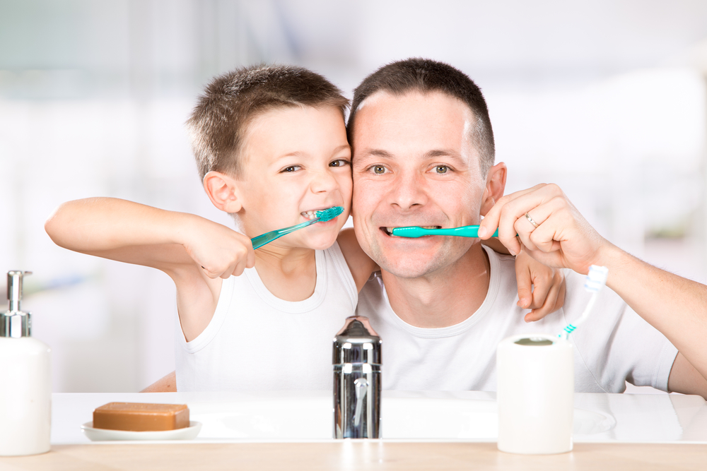 Тато і син чистять зуби