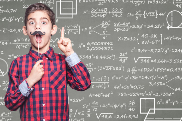 Мальчик-вундеркинд у доски с математическими формулами