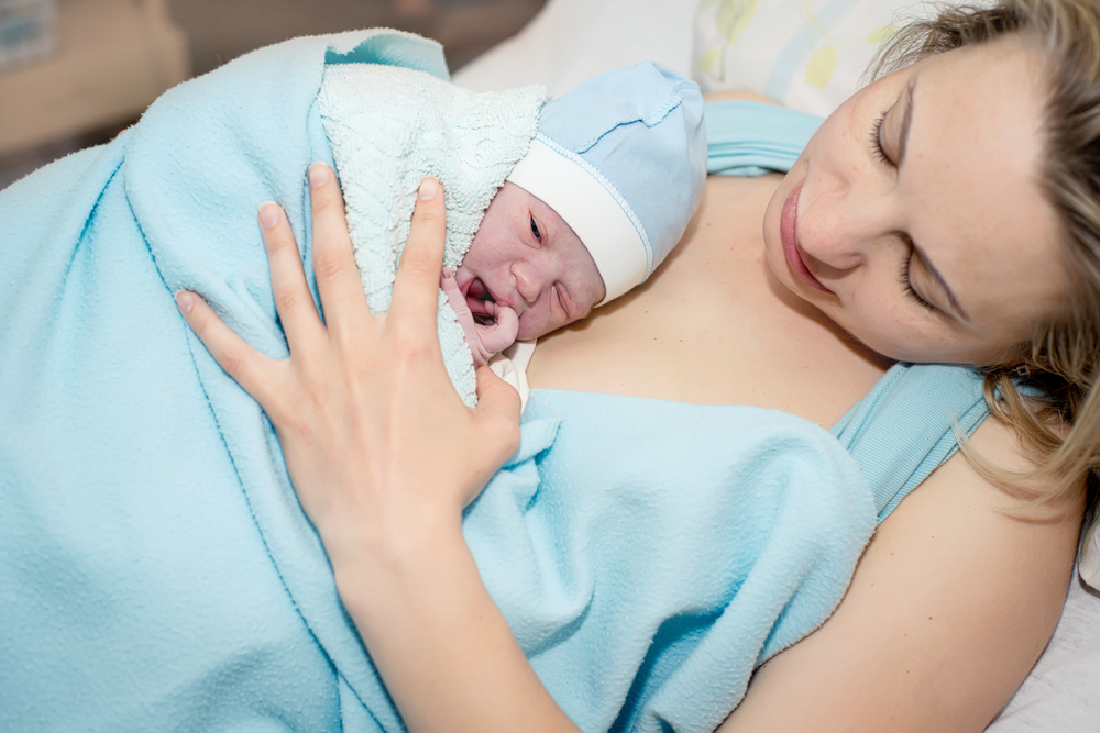 Новорожденный на груди у мамы после родов