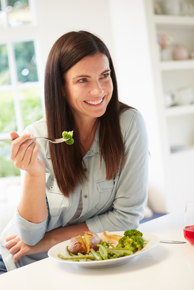 Жінка їсть салат 
